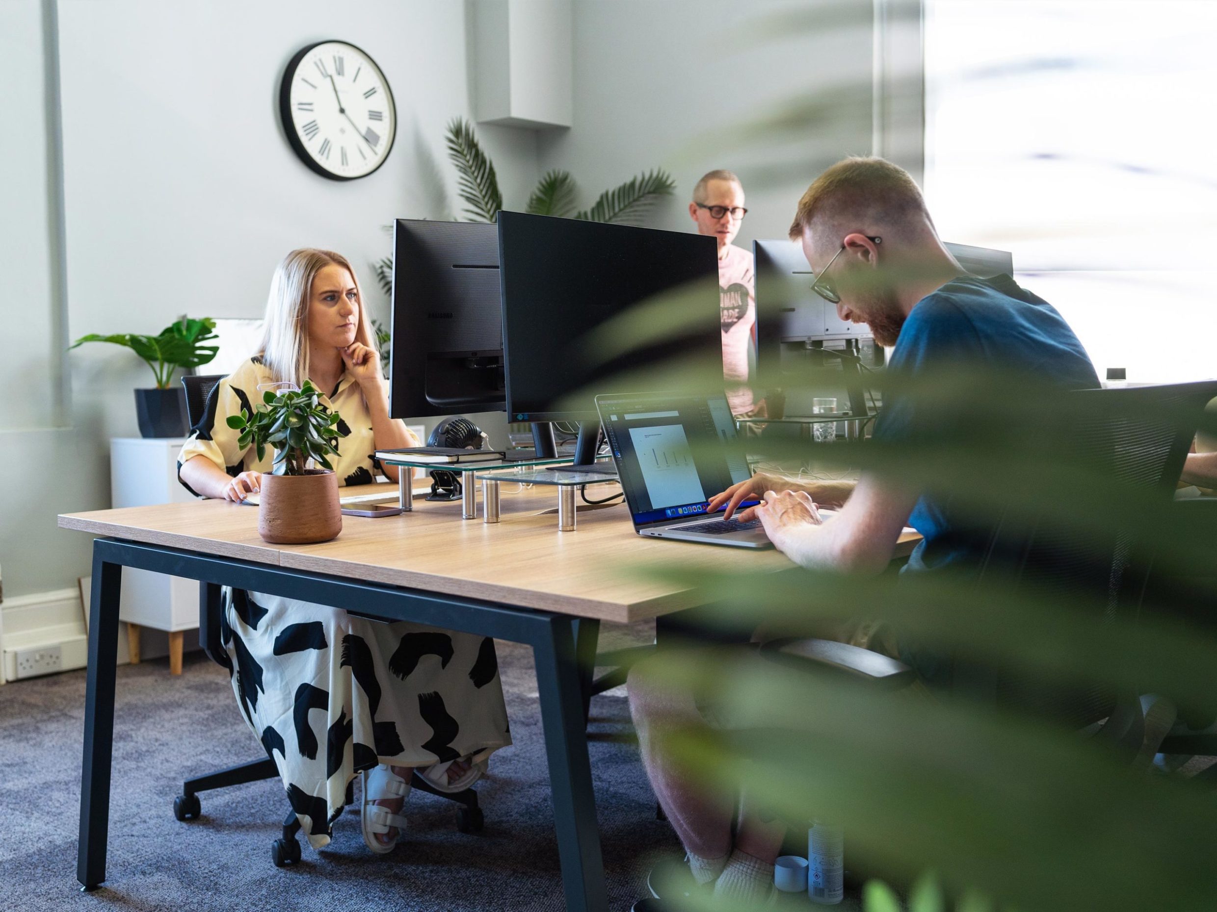A design agency team collaborates on a graphics report in their office.