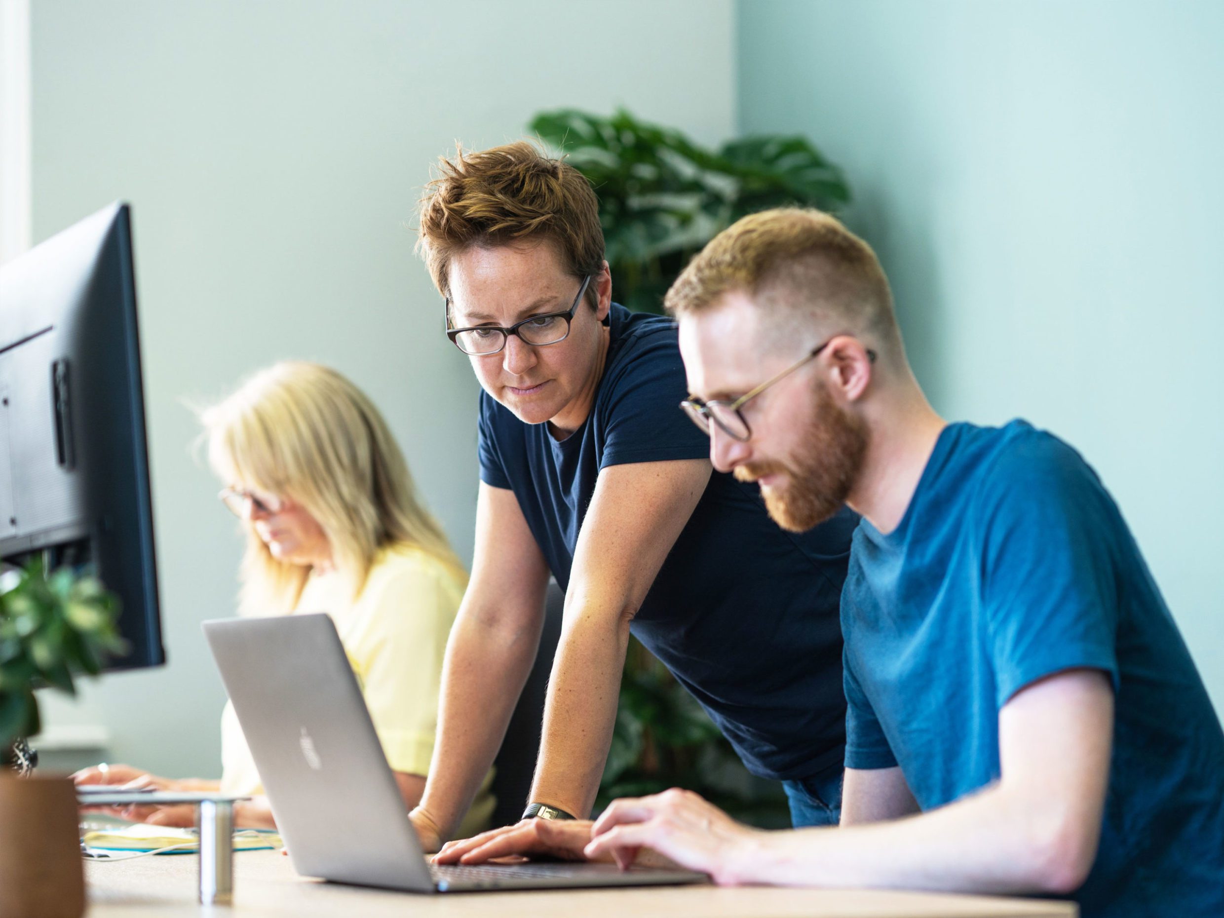 A design agency team collaborates on a graphics report in their office.